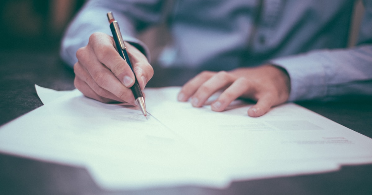 Professional reviewing compliance documents at a desk in a modern Dubai office
