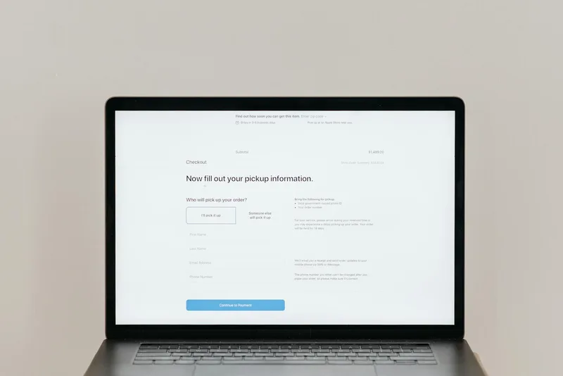 Laptop displaying an online registration form for business setup