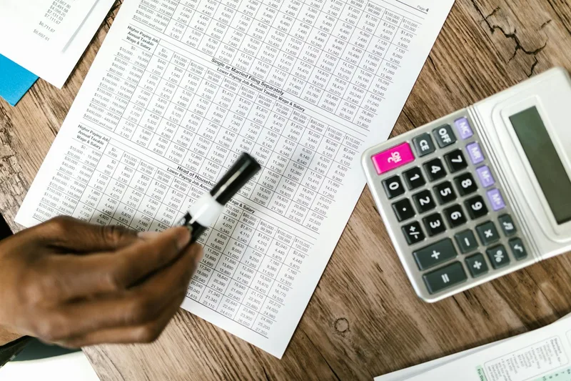 Tax documents and calculator on a desk illustrating business tax comparison